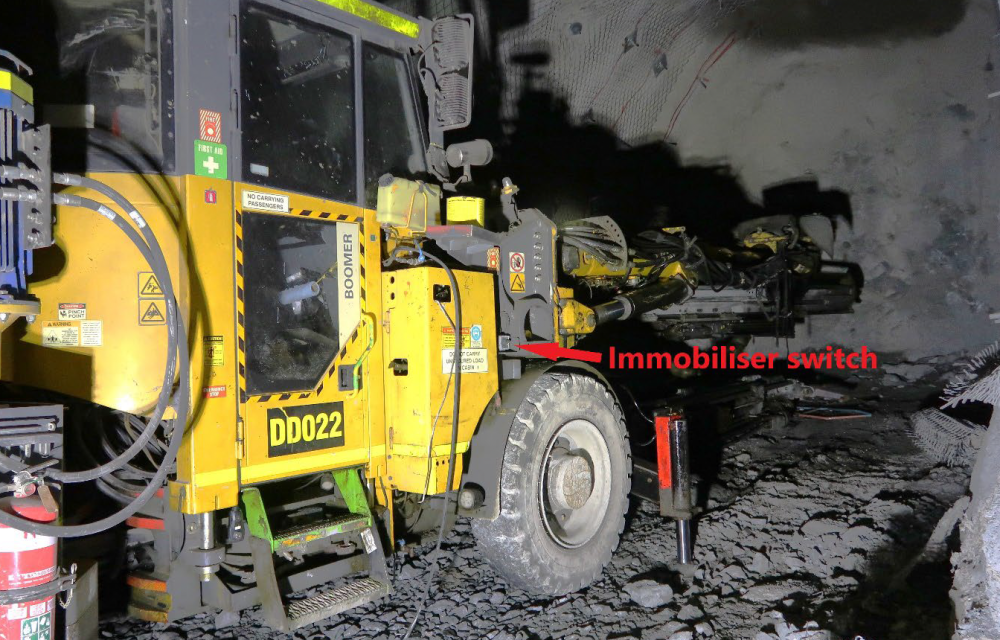 Jumbo drill rig at Cadia East with immobiliser switch highlighted and drill steel showing entangled work shirt, marking the scene of a traumatic arm amputation incident.