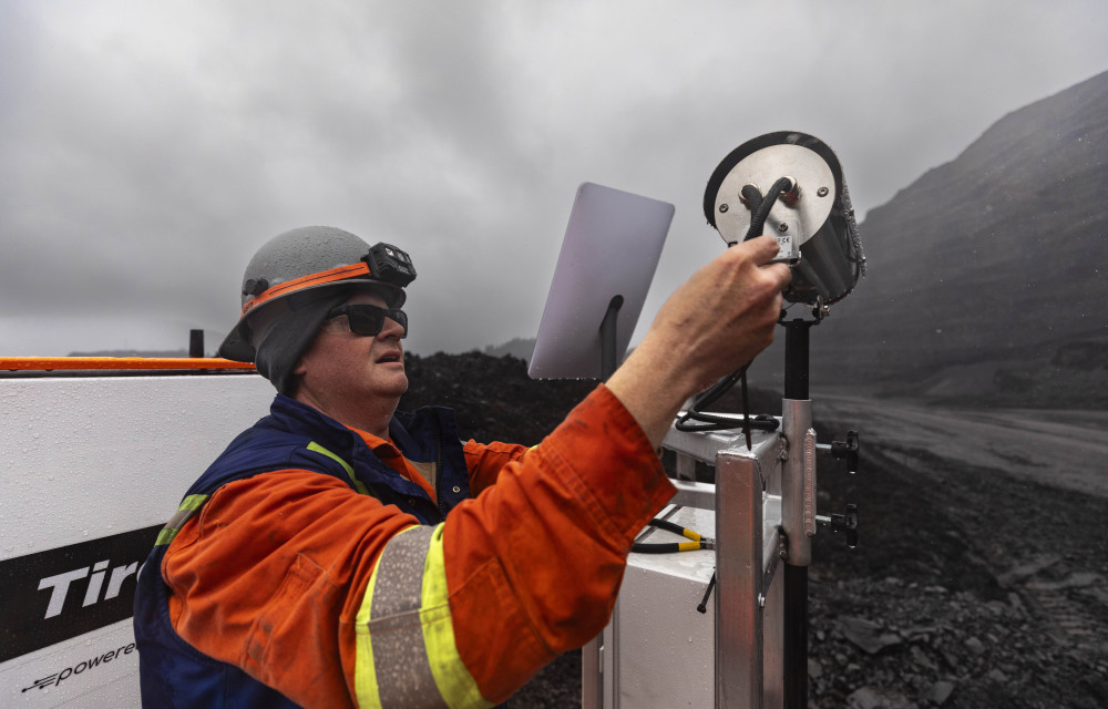 A Kal Tire technician services a TireSight thermal camera under challenging weather conditions demonstrating the system’s adaptability in harsh environments.