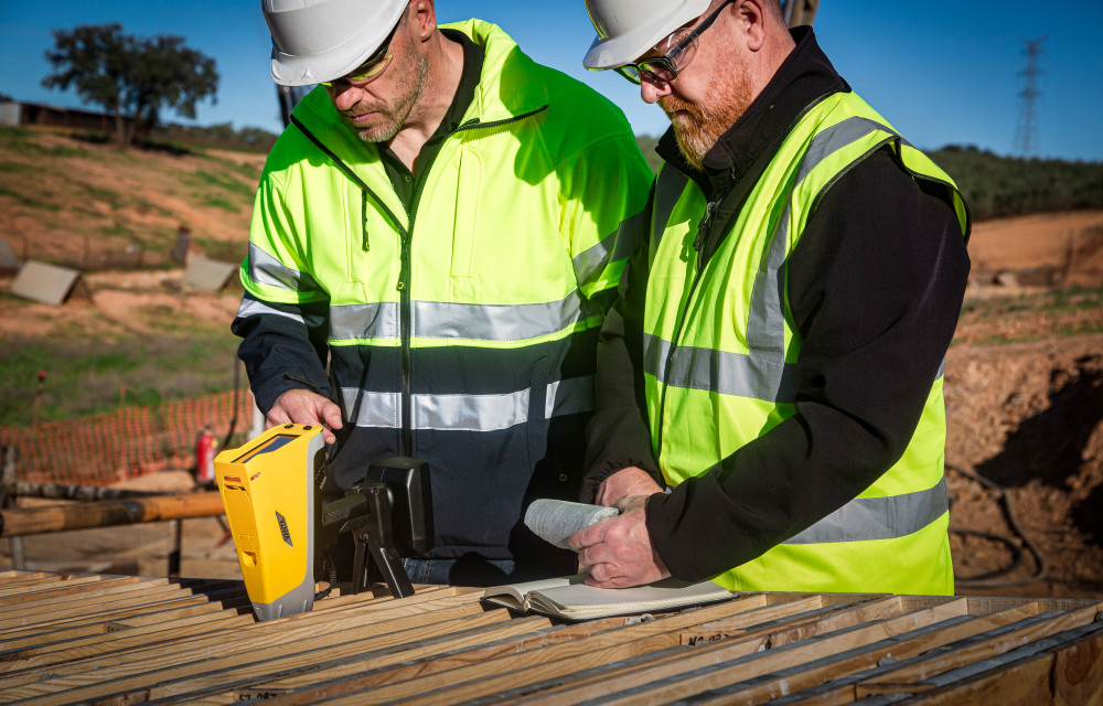 Geologists using Vanta handheld XRF analyser for rapid geochemical analysis in a remote exploration site